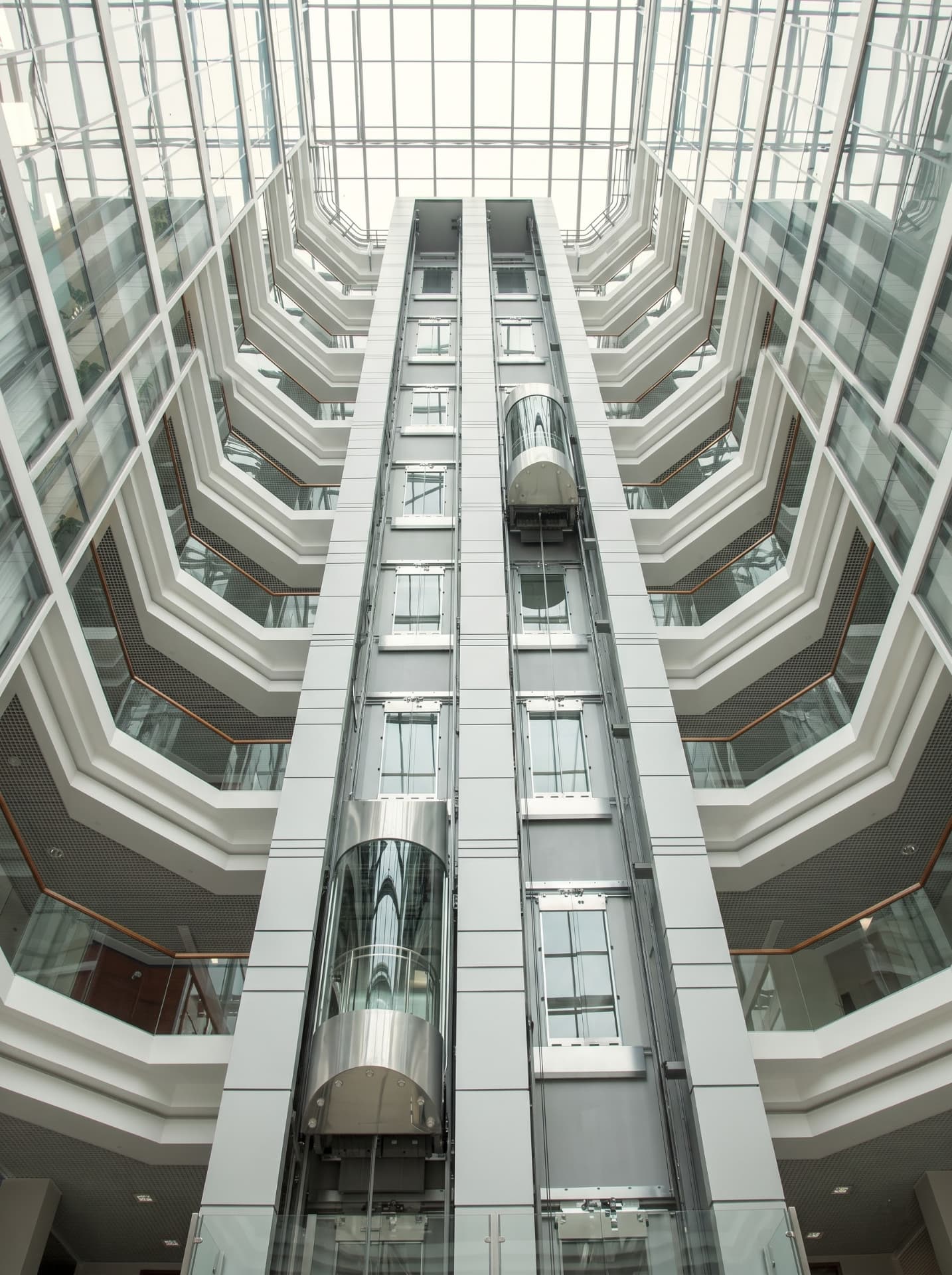 Panoramic commercial passenger lifts in a modern hotel atrium